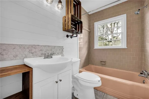 a bathroom with a sink a toilet and bathtub