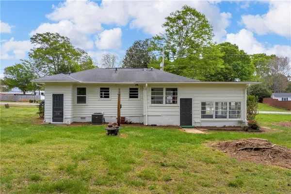 a backyard of a house with yard and barbeque oven