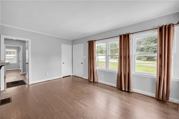 an empty room with windows and closet