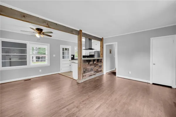 wooden floor in an empty room with a window