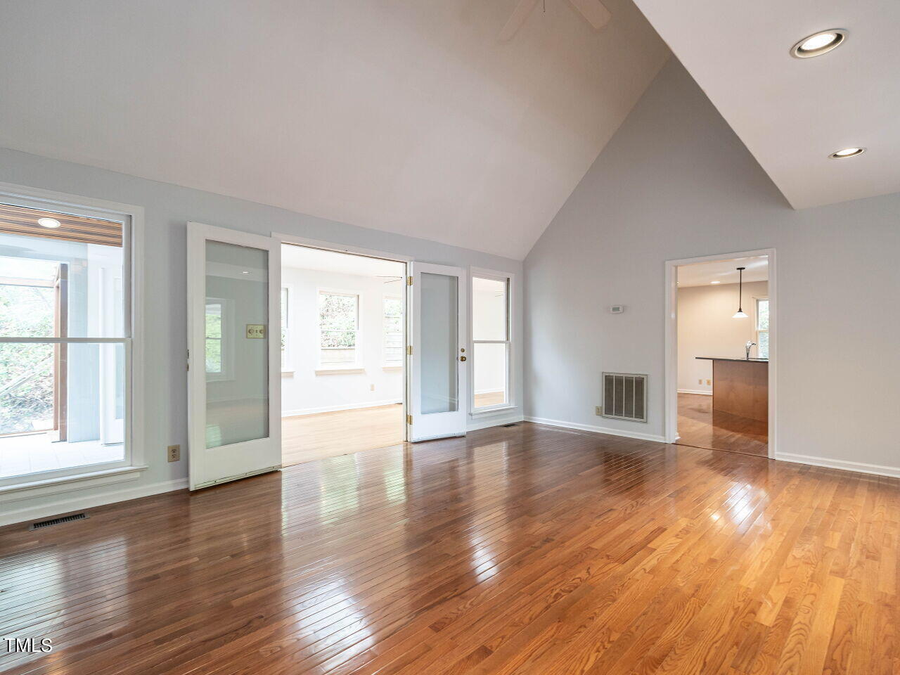 3309 Cobblestone Court Raleigh, NC 27607 - Photo 3 of 38 a view of an empty room with wooden floor and a window