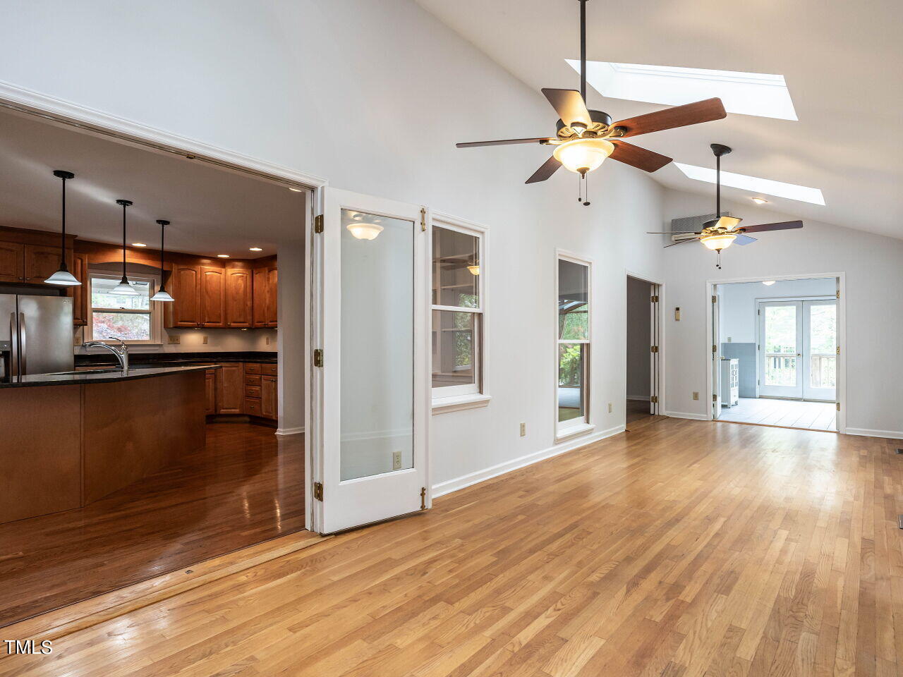 3309 Cobblestone Court Raleigh, NC 27607 - Photo 9 of 38 an empty room with wooden floor fan and windows