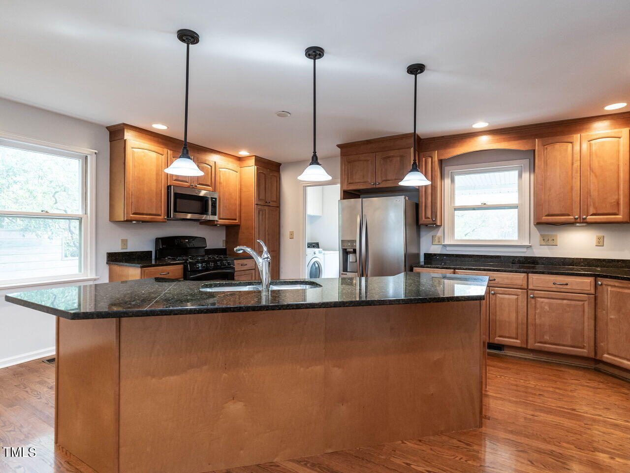 3309 Cobblestone Court Raleigh, NC 27607 - Photo 10 of 38 a kitchen with stainless steel appliances granite countertop a sink a window and chairs