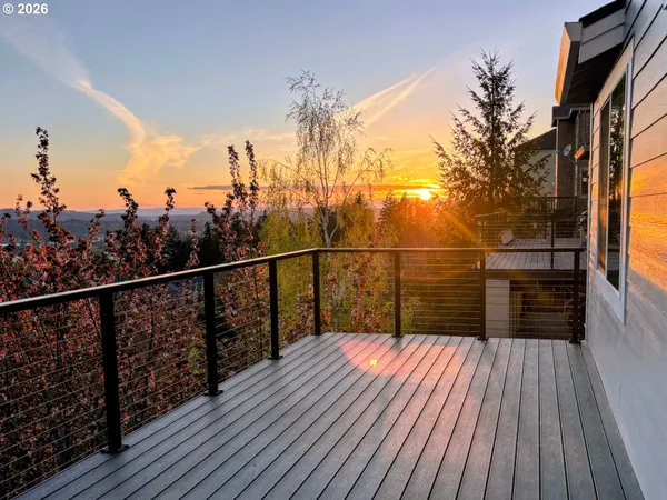 a view of balcony with wooden floor and fence