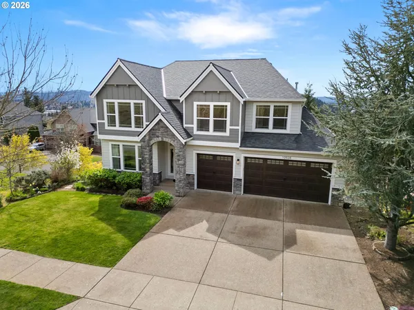 a front view of a house with a yard and garage