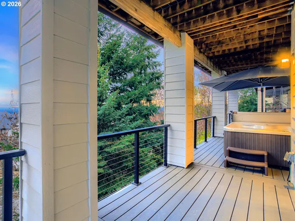 a view of balcony with wooden floor and fence