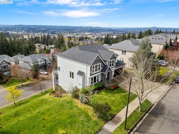 an aerial view of a house with a yard and lake view
