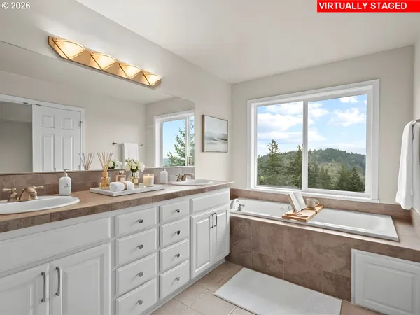 a bathroom with a tub a sink and mirror