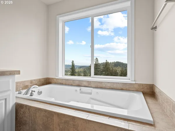 a view of a bath tub sitting in a bathroom next to a window
