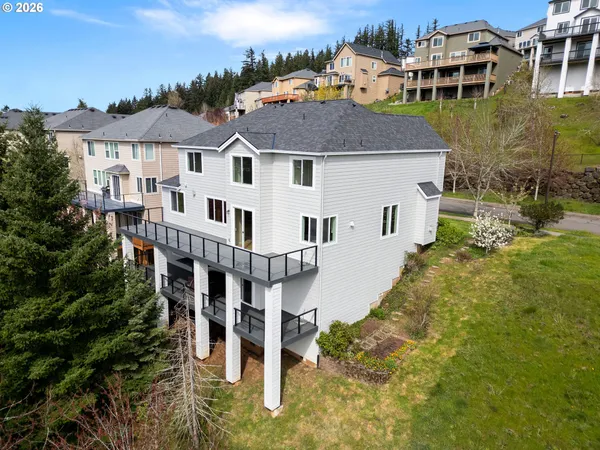 an aerial view of residential houses with yard