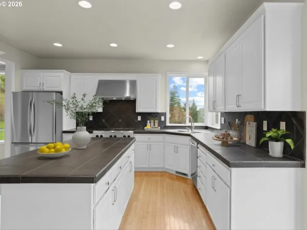 a kitchen with a sink appliances and cabinets