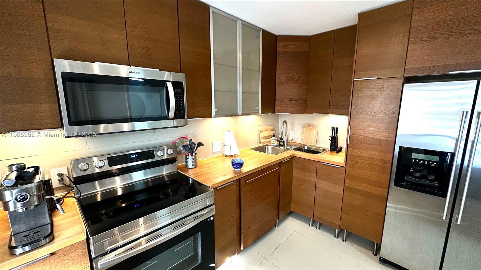 a kitchen with stainless steel appliances a stove a sink and a microwave