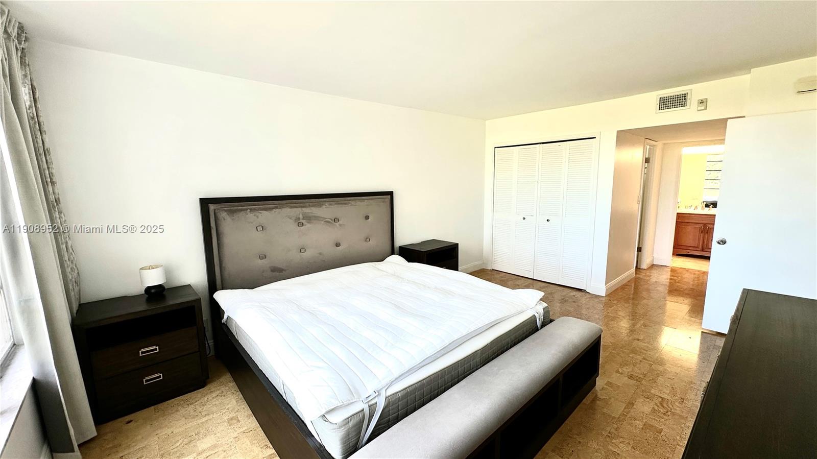2651 South Course Drive, Unit 307 Pompano Beach, FL 33069 - Photo 15 of 33 a bedroom with a bed and wooden floor