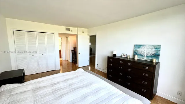 a bedroom with a bed and a mirror