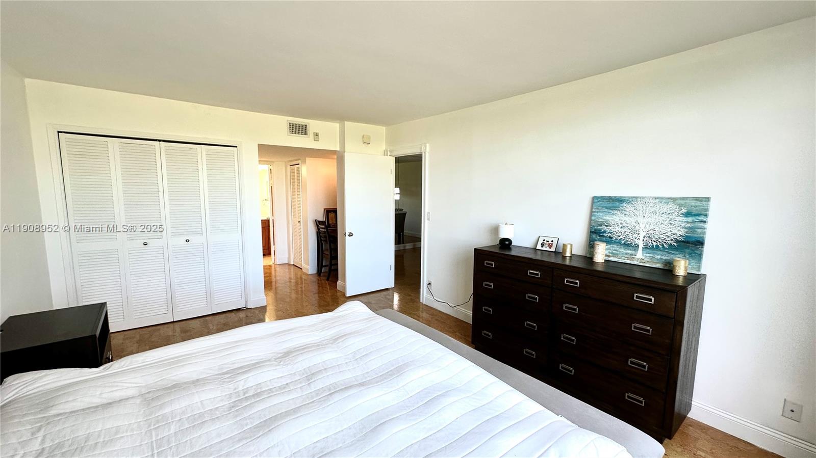 2651 South Course Drive, Unit 307 Pompano Beach, FL 33069 - Photo 16 of 33 a bedroom with a bed and a mirror