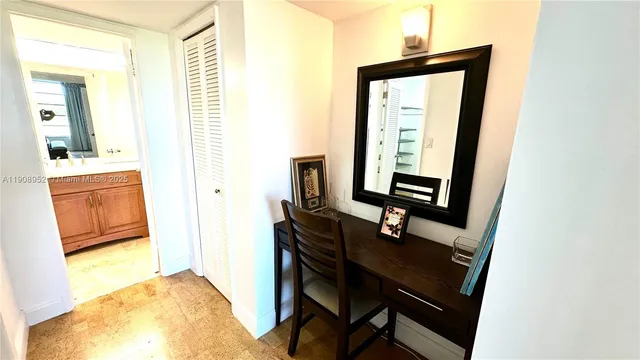 a view of a workspace room with wooden floor and a bathroom
