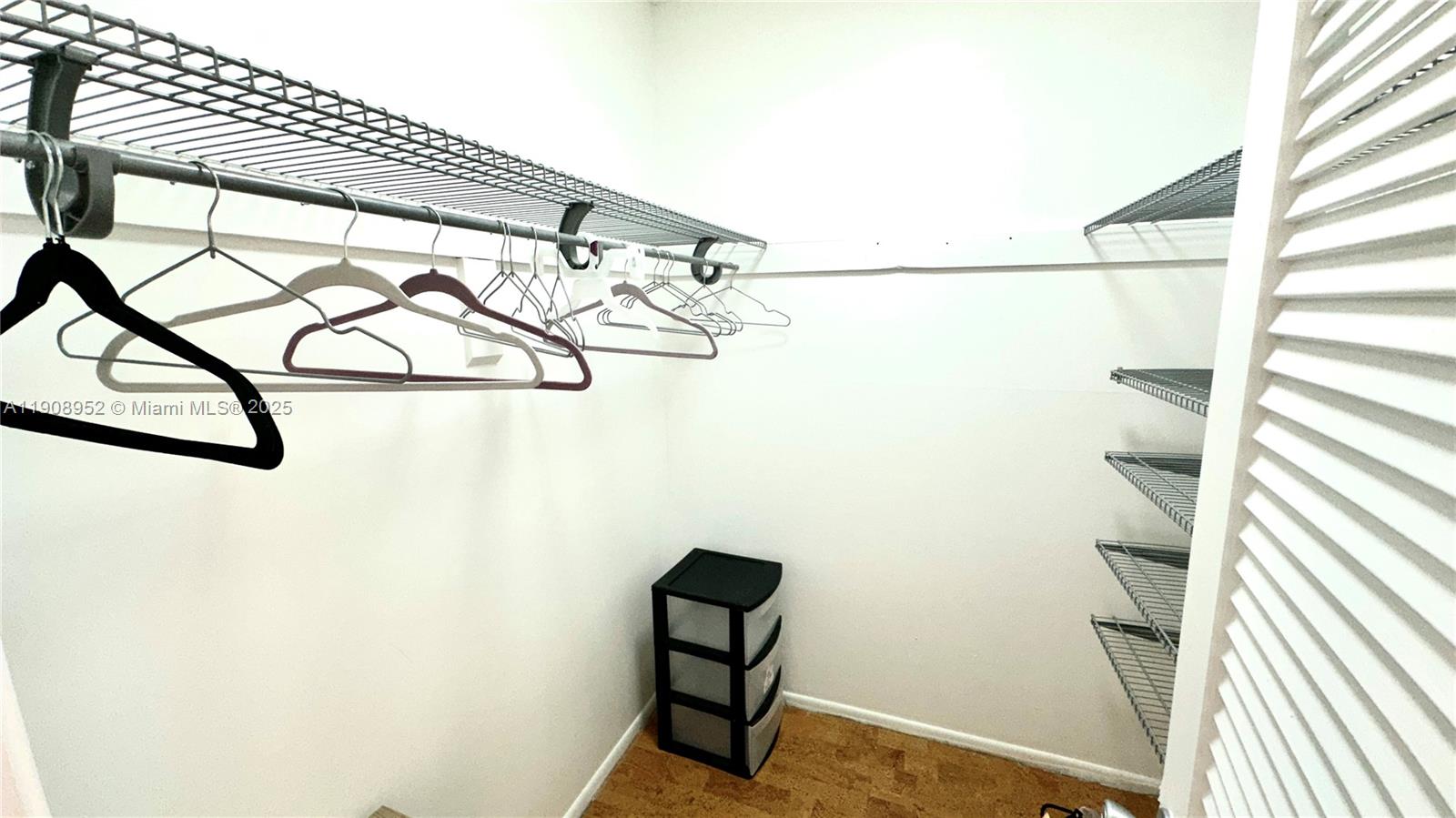 2651 South Course Drive, Unit 307 Pompano Beach, FL 33069 - Photo 20 of 33 a view of walk in closet with clothes