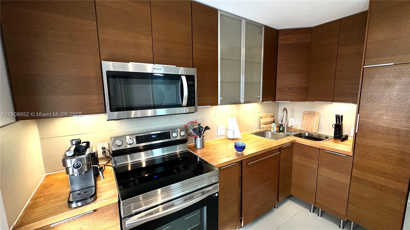 2651 South Course Drive, Unit 307 Pompano Beach, FL 33069 - Photo 2 of 33 a kitchen with a sink appliances and cabinets