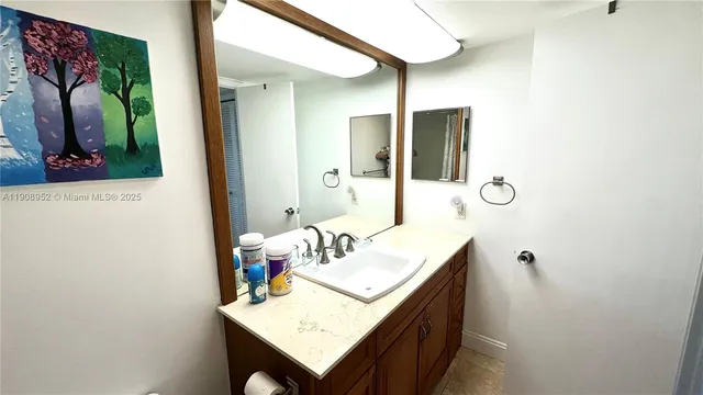 a bathroom with a sink vanity and a mirror
