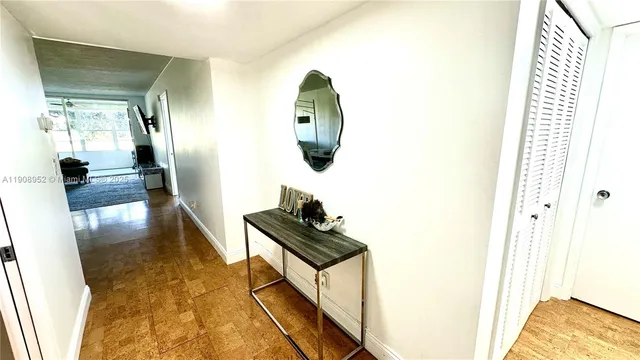 a living room with furniture and a mirror