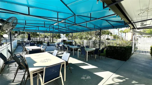 a view of a tables and chairs under an umbrella