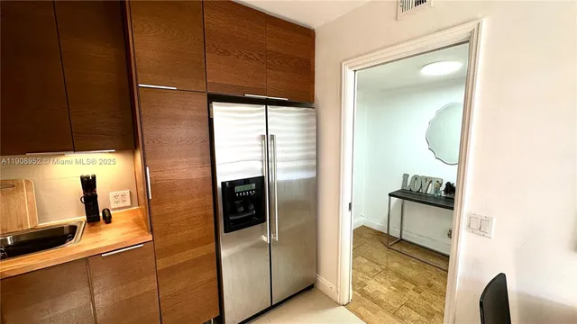 a kitchen with stainless steel appliances granite countertop a refrigerator and a stove