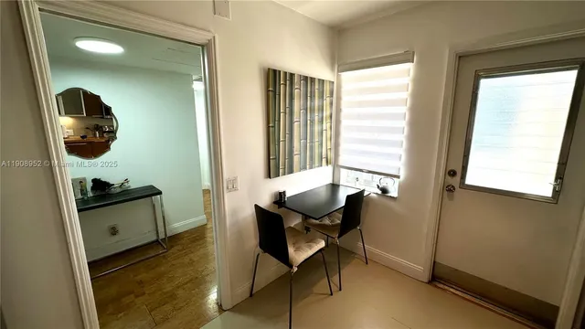 a view of a workspace with furniture and a window