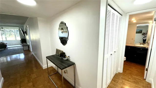a view of a hallway view with wooden floor and staircase