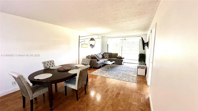 a view of a dining room with furniture and a window