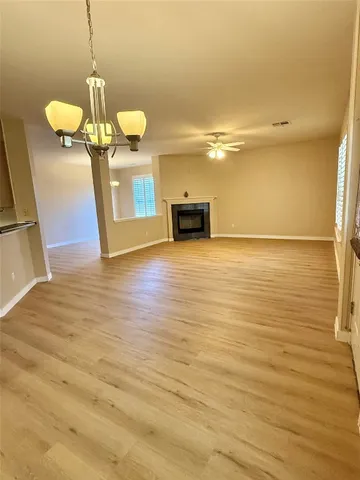 a view of a room with wooden floor