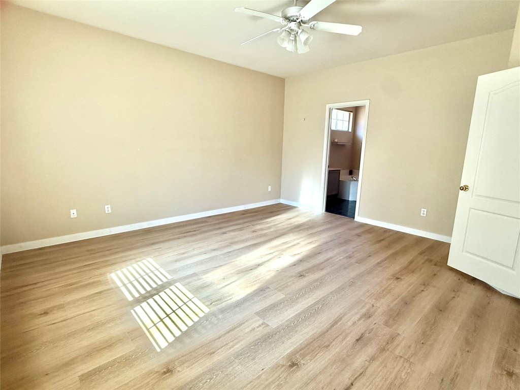 1511 Freestone Drive Pflugerville, TX 78660 - Photo 9 of 12 a view of wooden floor and cabinet in a room