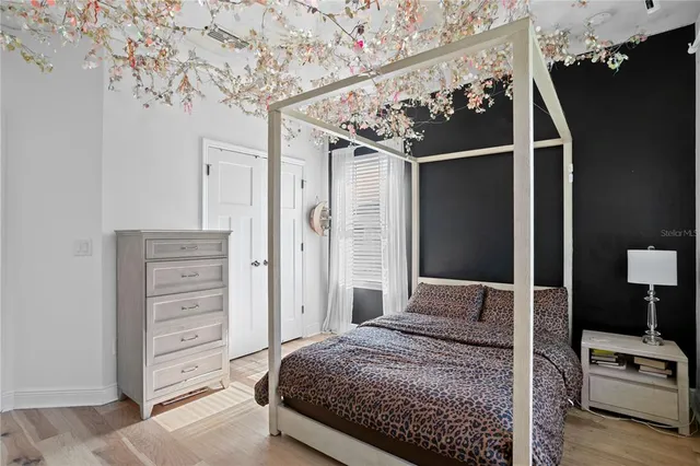 a bedroom with a bed couch and window