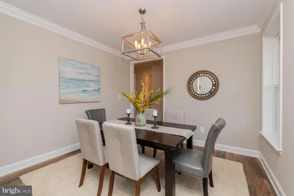 a view of a dining room with furniture and a chandelier