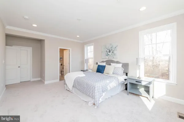 a spacious bedroom with a large bed and a window