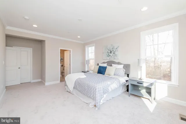 a spacious bedroom with a large bed and a window