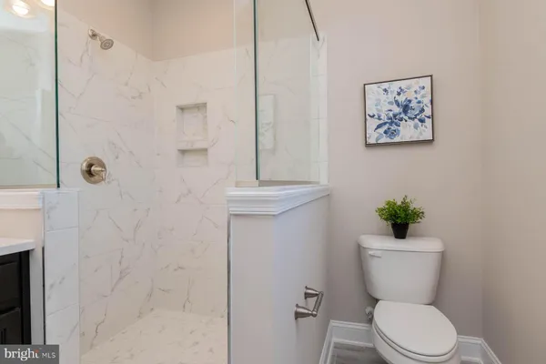 a bathroom with a toilet a sink and shower