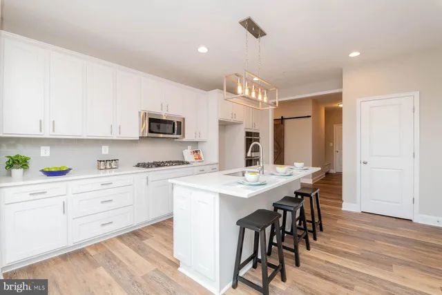 a kitchen with a table chairs refrigerator and cabinets