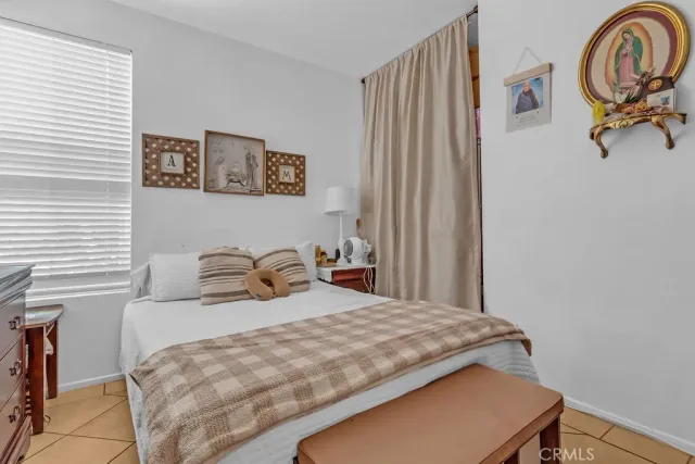 a bedroom with a bed and a dresser