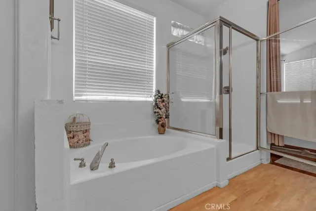 a bathroom with a bathtub and a shower