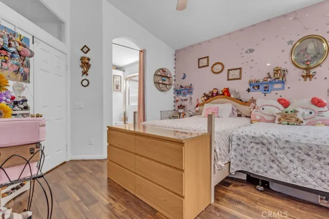 a room with a bed and a dresser