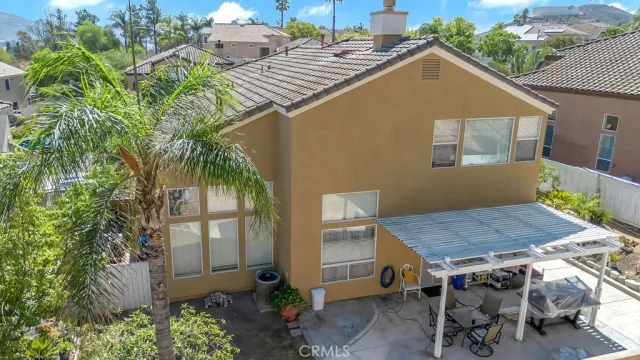 a backyard of a house with table and chairs