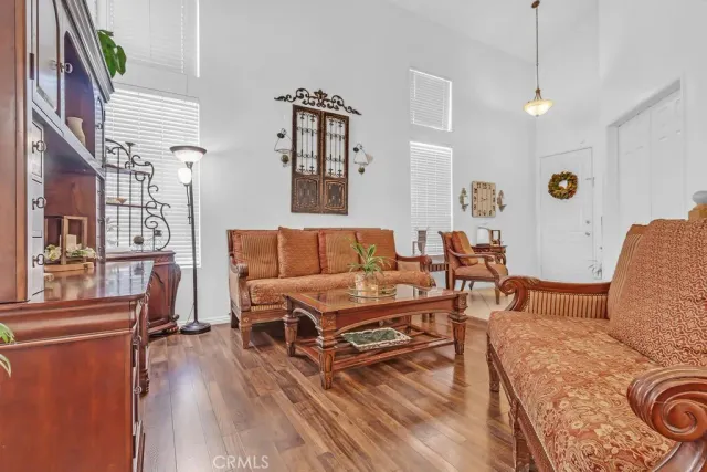 a living room filled with furniture and a wooden floor