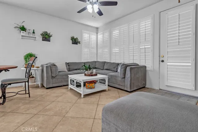 a living room with furniture and a potted plant