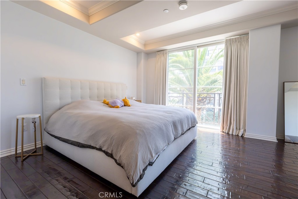 10795 Wilshire Boulevard, Unit 402 Los Angeles, CA 90024 - Photo 12 of 20 a large bed sitting in a bedroom next to a window