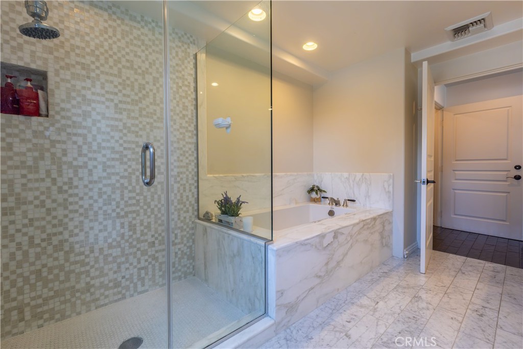10795 Wilshire Boulevard, Unit 402 Los Angeles, CA 90024 - Photo 17 of 20 a bathroom with a bathtub and shower