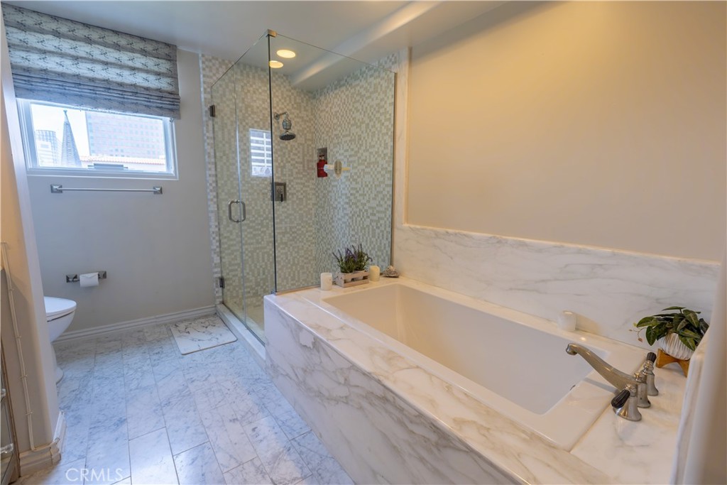 10795 Wilshire Boulevard, Unit 402 Los Angeles, CA 90024 - Photo 18 of 20 a bathroom with a tub and shower