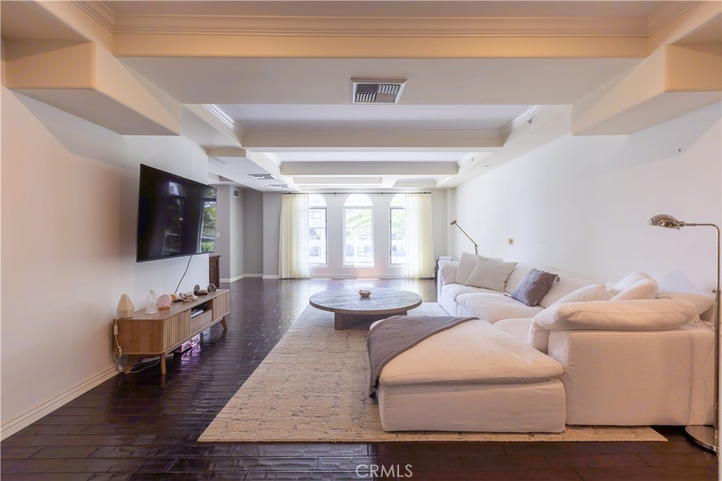 10795 Wilshire Boulevard, Unit 402 Los Angeles, CA 90024 - Photo 2 of 20 a living room with furniture a flat screen tv and a large window