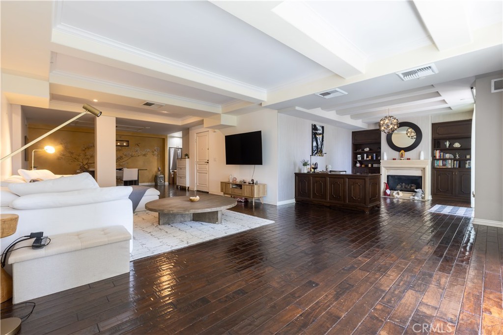 10795 Wilshire Boulevard, Unit 402 Los Angeles, CA 90024 - Photo 6 of 20 a living room with furniture and a flat screen tv