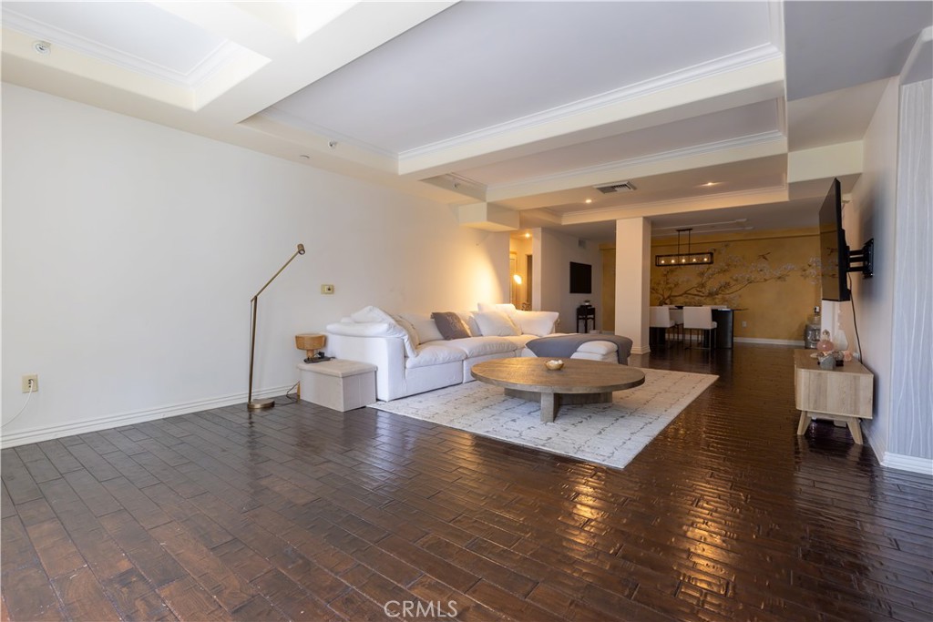 10795 Wilshire Boulevard, Unit 402 Los Angeles, CA 90024 - Photo 8 of 20 a living room with couches and a view of kitchen