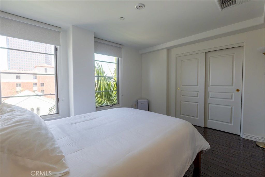10795 Wilshire Boulevard, Unit 402 Los Angeles, CA 90024 - Photo 9 of 20 a view of a bedroom with wooden floor and bedroom